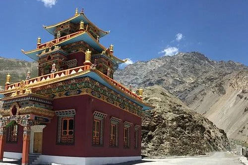A red and gold Buddhist monastery below bare mountains in Spiti